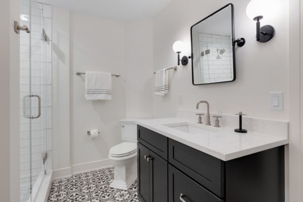 Cozy modern bathroom with white and black tones and a single vanity
