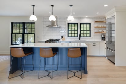 Kitchen island with three high-boy chairs and lots of storage space
