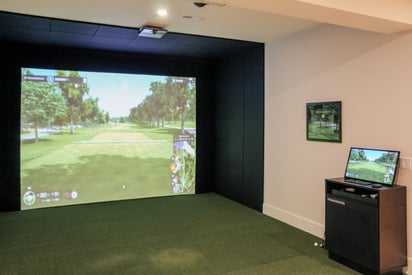Home golf simulator with impact net and a projector mounted in the basement
