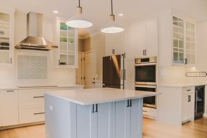 Contemporary kitchen remodel with baby blue kitchen island, stainless steel appliances, and white storage spaces throughout the space