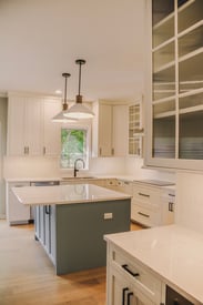 Contemporary and elegant kitchen remodel with white countertops and lots of storage space for efficiency