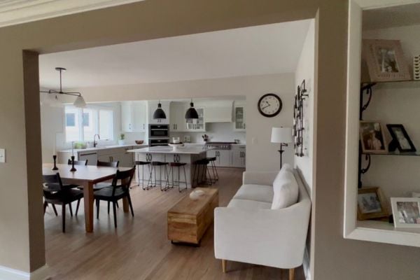 Naturally lit kitchen and dining room with a white couch seating area