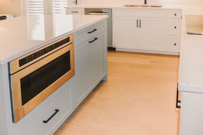Kitchen island drawers with an undermounted microwave over in the kitchen island