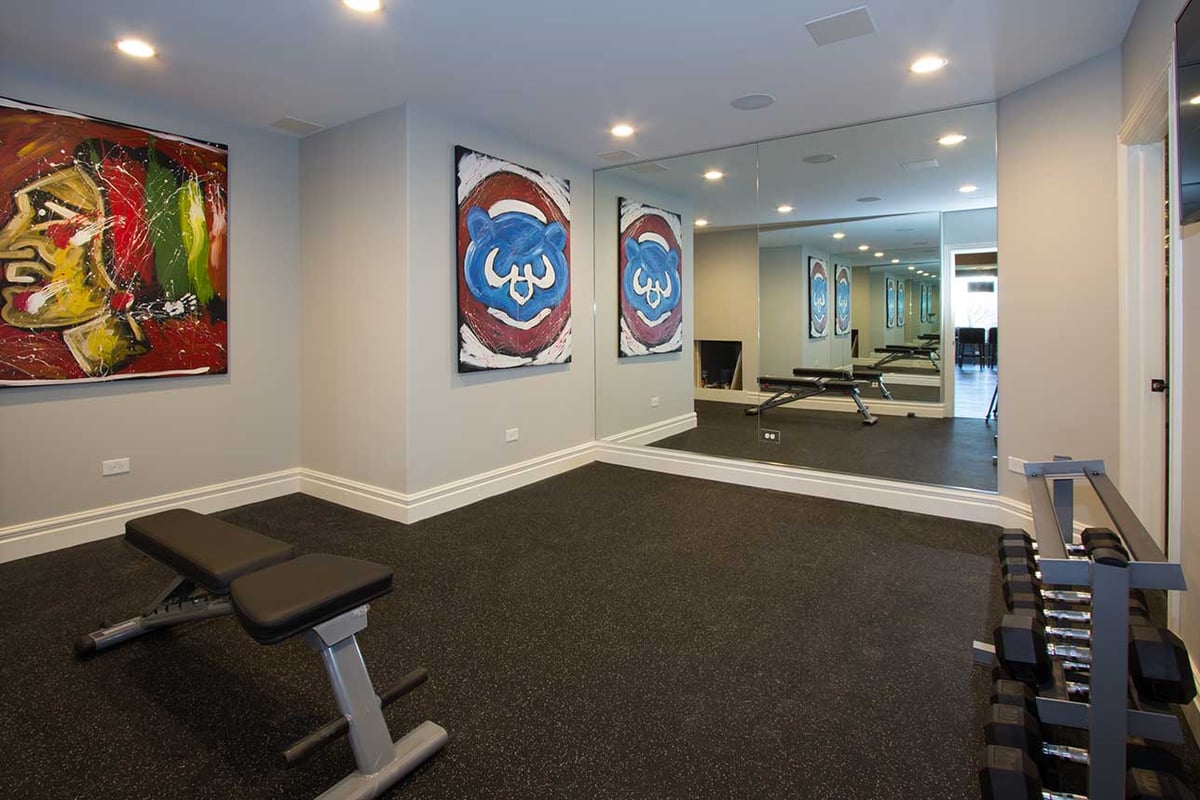 Workout area in a basement remodeled by Hogan Design and Construction
