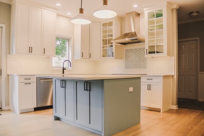 Kitchen island with added storage under the seating area with two pendant lights overhead
