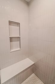 A walk-in shower bench and built-in shelf for extra space and elegance