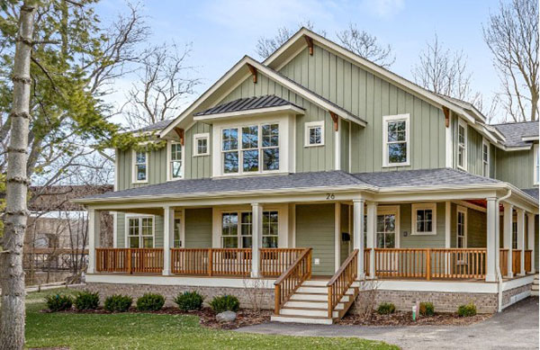home-exterior-with-green-cedar-siding-and-a-wrap-around-front-porch