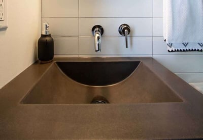brown sink basin in the bathroom with simple fixtures