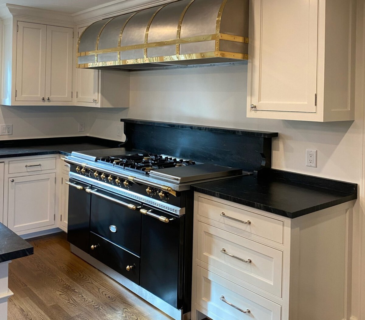 A Kitchen with Caramage Cook Stove built-in with saopstone countertop