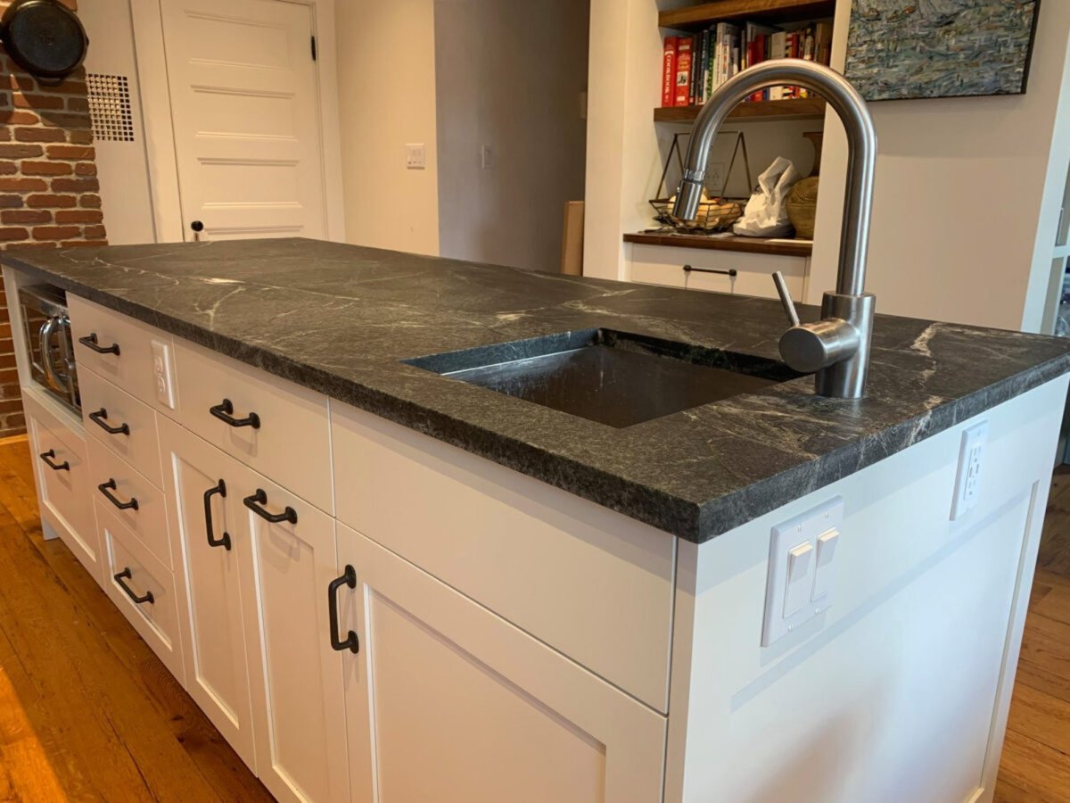 Close-up of a kitchen soapstone island with a sink by Soapstones.com