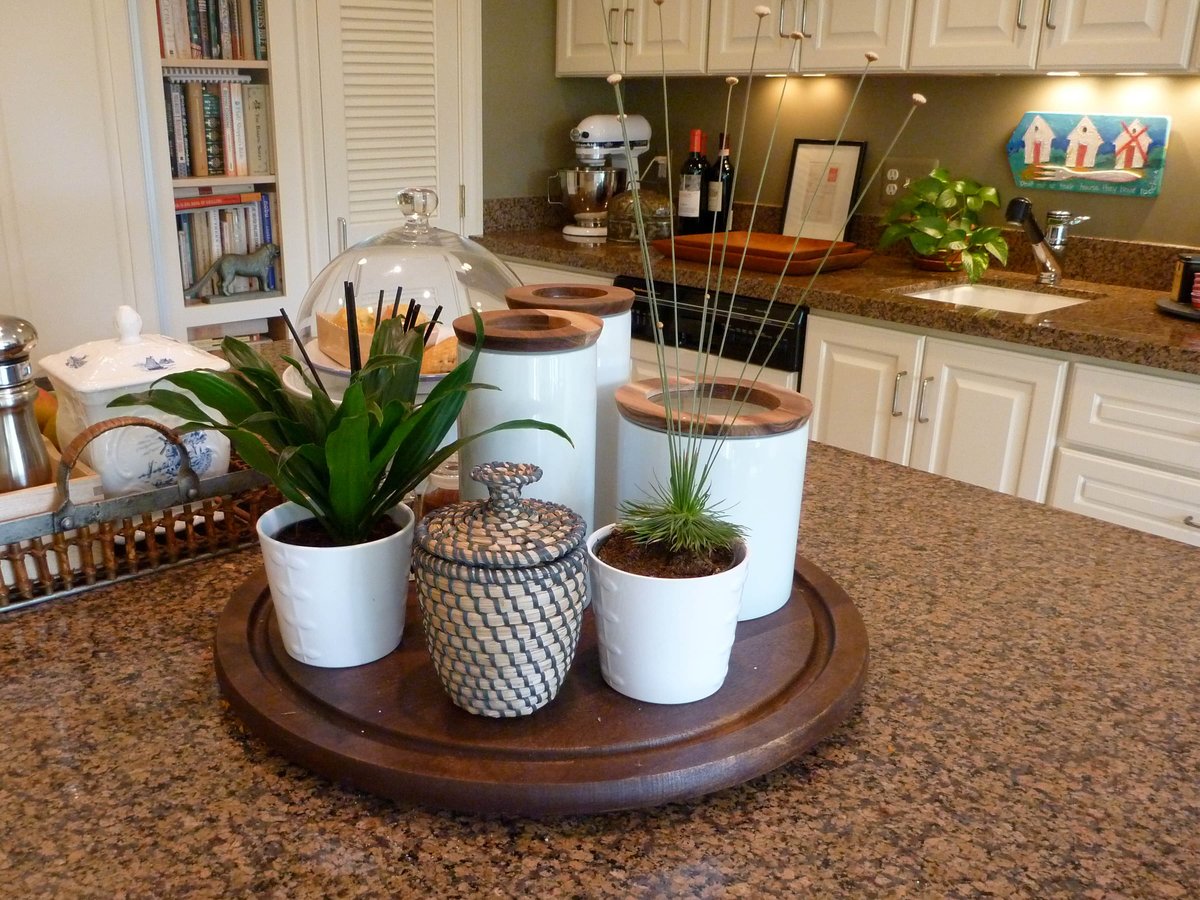 A lazy susan and an antique basket filled with cooking items