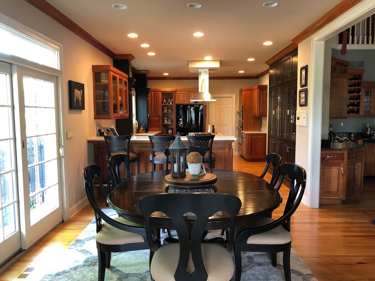 A wooden lazy susan on a round dining table in a kitchen