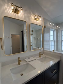 Close up of two side by side mirrors for a double vanity in a master bathroom