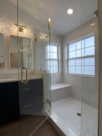 Glass door entrance to a walk in shower