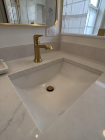 Bathroom sink and basin with gold fixtures