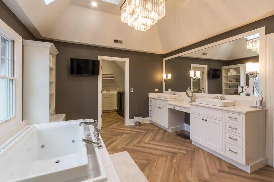 Luxury bathroom with porcelain flooring with double vanity and a bath tub