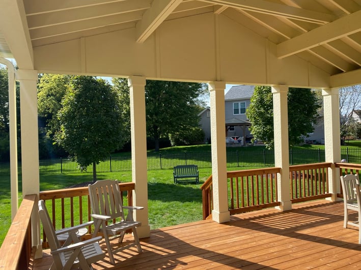 Covered porch over raised deck with trestle ceiling