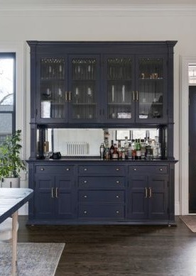 Kitchen navy hutch_bar with glass panel upper cabinets and gold hardware, featuring a mirrored back-1-1-1