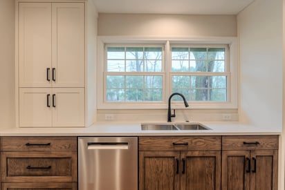 Kitchen sink in front of a double window in a luxury kitchen remodel