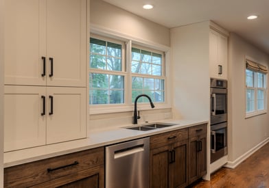 White wooden cabinetry and dark wood cabinetry beneath the counter tops for lots of kitchen storage space