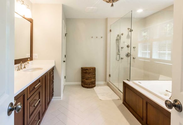 Contemporary and simple bathroom remodel with wood trim and a seamless walk-in shower
