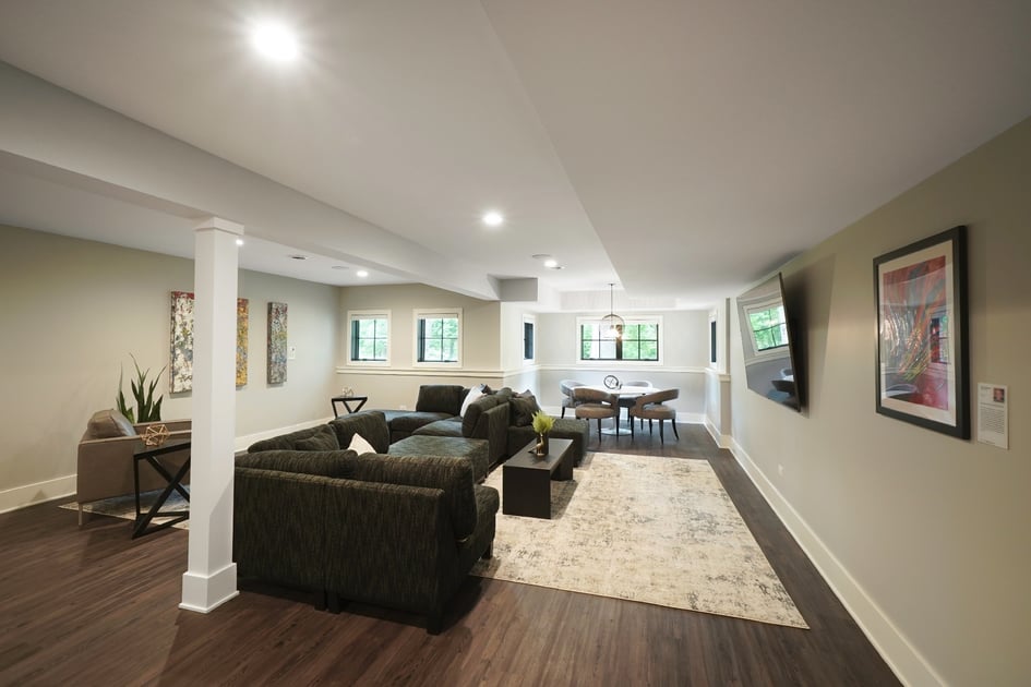 Basement with large windows allowing daylight to filter into the basement
