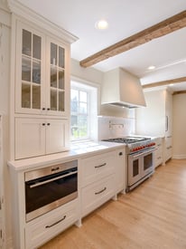 Wide angle of a kitchen remodel counter top with built in luxury appliances