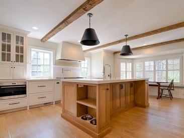 Kitchen island with a cut out for additional storage and dog food bowls without a door in the way
