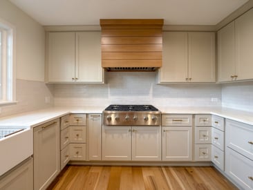 Spacious kitchen remodel with stainless steel range and exhaust hood mounted above