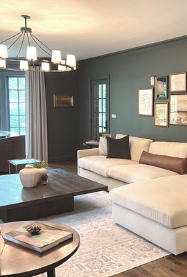www-hogandesignandconstruction-comhubfsLiving room with a wagon wheel chandelier, a large sectional sofa and a small dining table-1-1-1-1-1