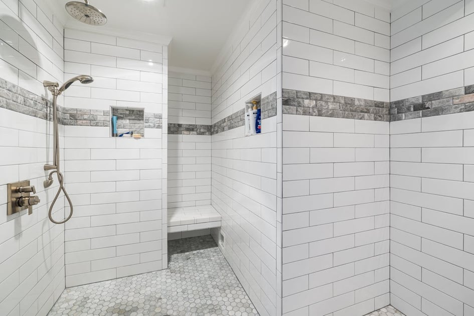 Bathroom and bath area decked out in brick-styled tiles