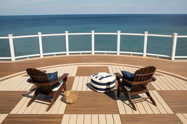 Checkerboard patterned decking with water view and Adirondack chairs